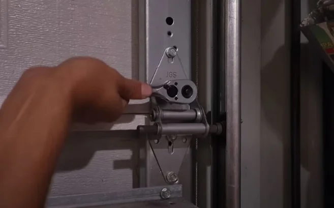 tightening the bolt of a garage door